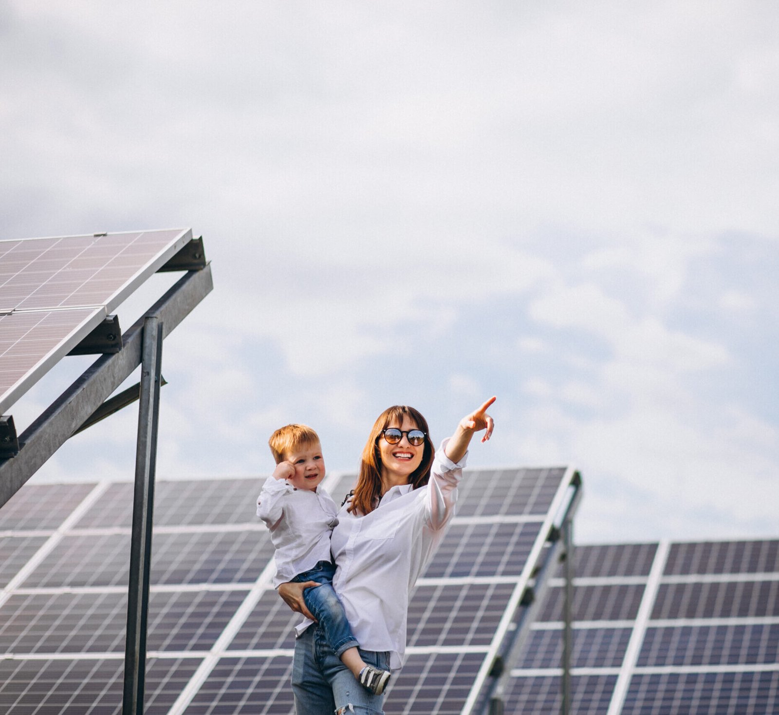 Mother with her little son by solar panels